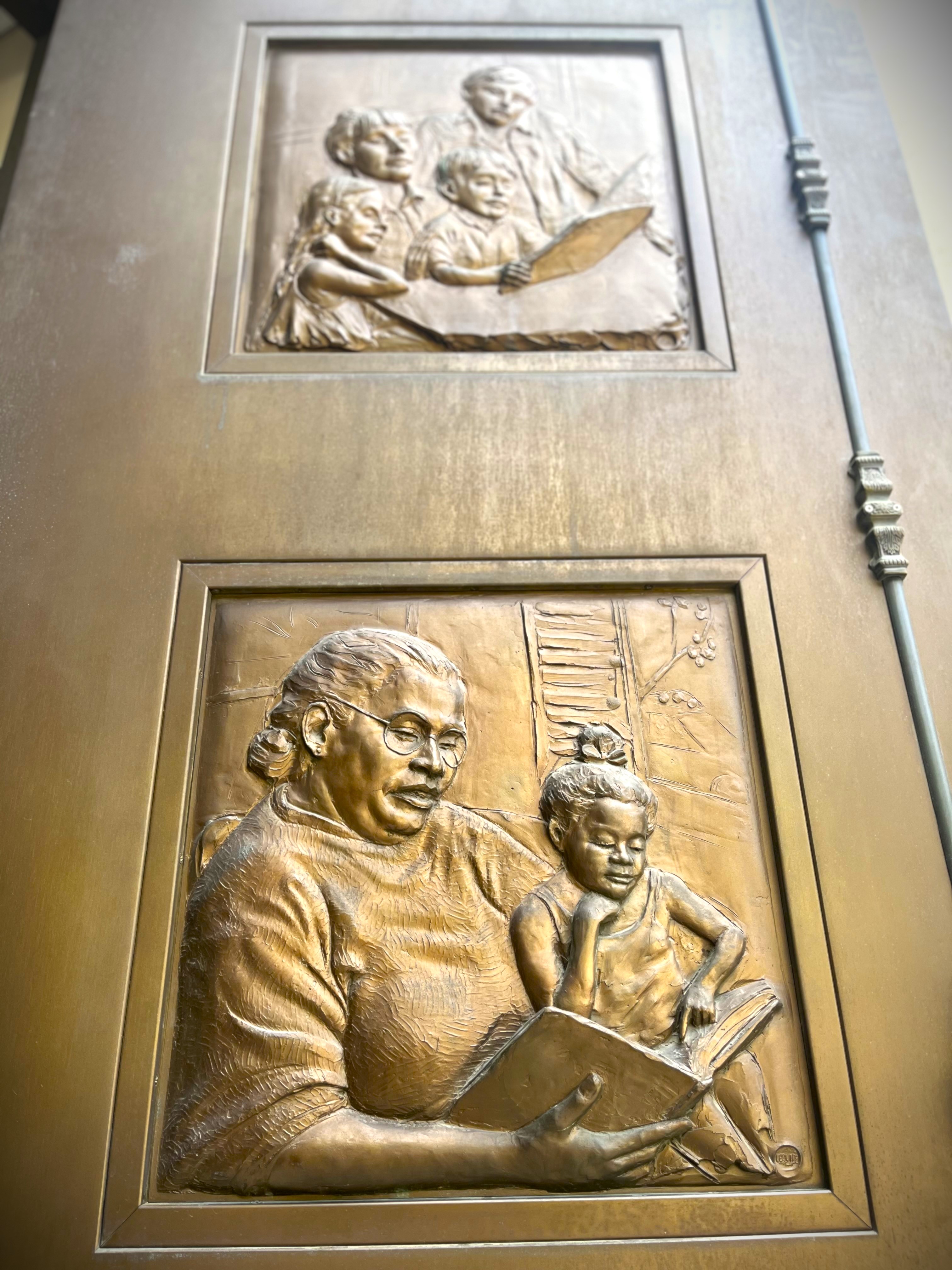 Up close view of the bronze doors on the front of the downtown library