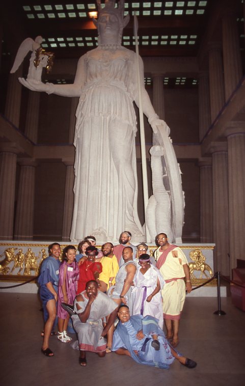 Photo of several people in Greek attire posing in front of the Athena statue inside the Parthenon in the year 1992