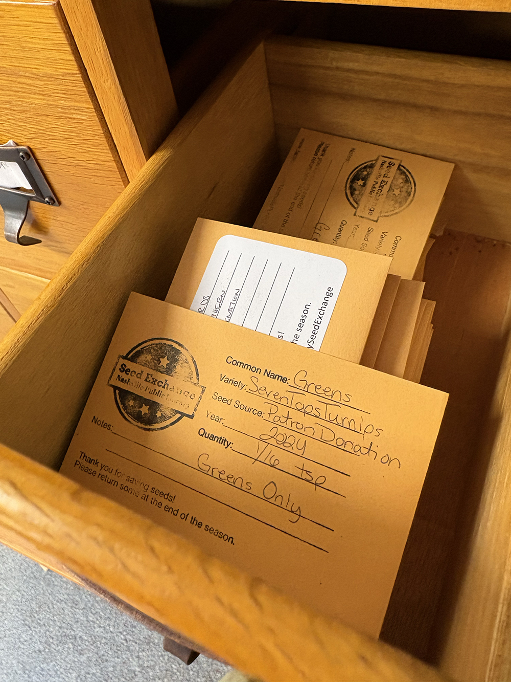 A cabinet with tiny drawers houses packets of seeds for people to borrow at Richland Park Branch Library.