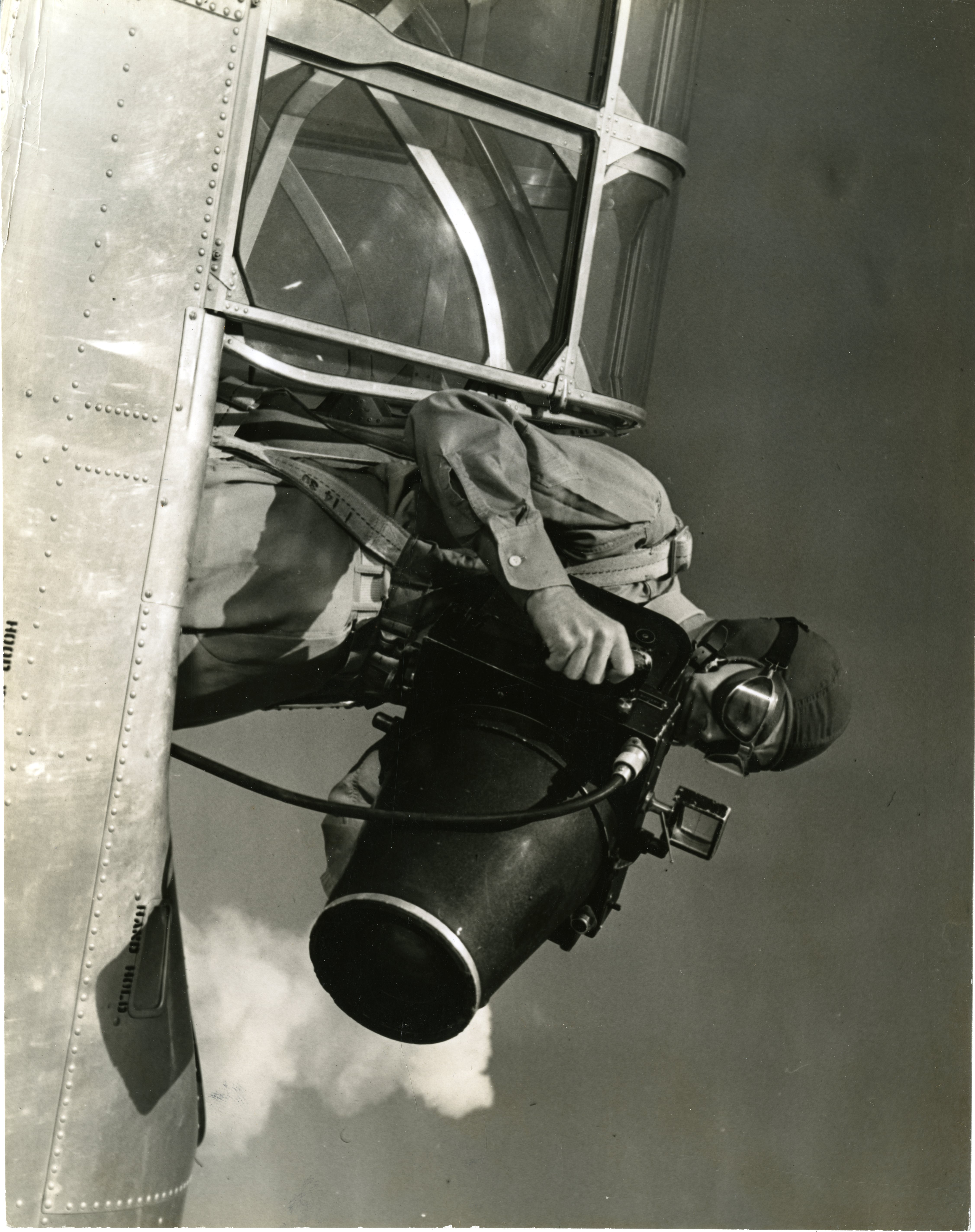 Photo of man in airplane taking aerial photo of the city