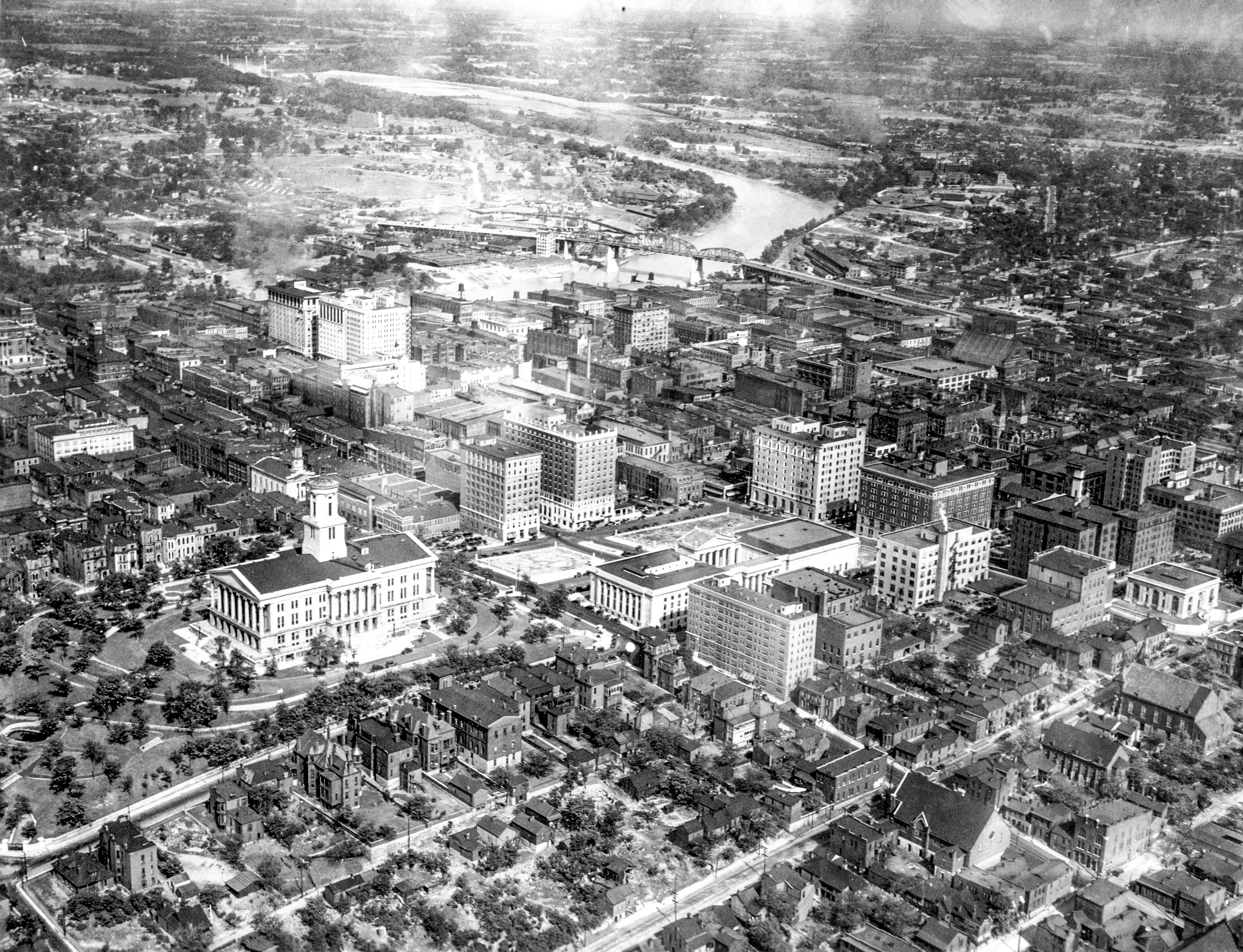 Aerial photo of downtown Nashville from approximately the 1930s with the state capitol building in the forefront and east nashville in the background