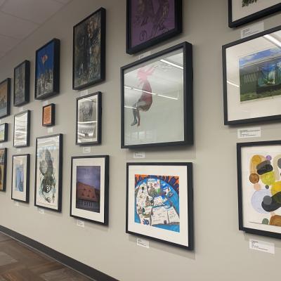 Framed artwork displayed on a white wall.