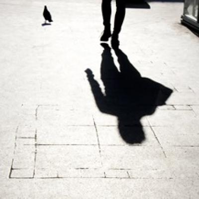 Shadow of a person on pavement.
