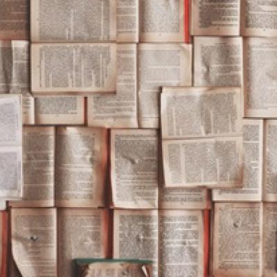 Rectangle showing open books layered on top of one another.