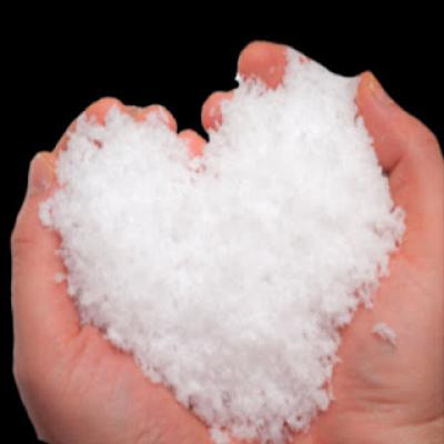 Two hands holding show shaped like a heart.