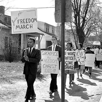 John Lewis marching for civil rights.