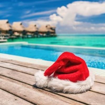 Santa hat on a boardwalk at the beach.