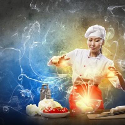 Chef cooking with a magical light surrounding her.