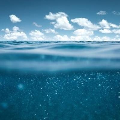 The ocean with clouds in the sky.