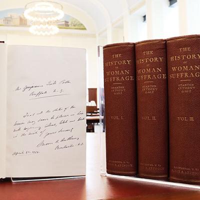 History of Women's Suffrage Books standing on end.