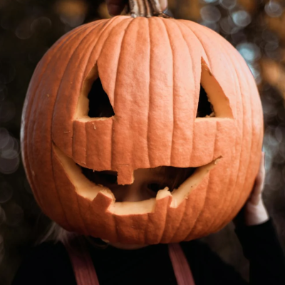 Pumpkin with carved eyes and a mouth.