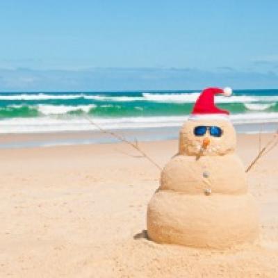 Snowman made of sand on a beach.