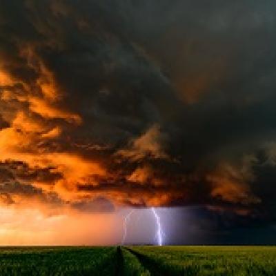 Stormy night sky with lightning hitting the ground