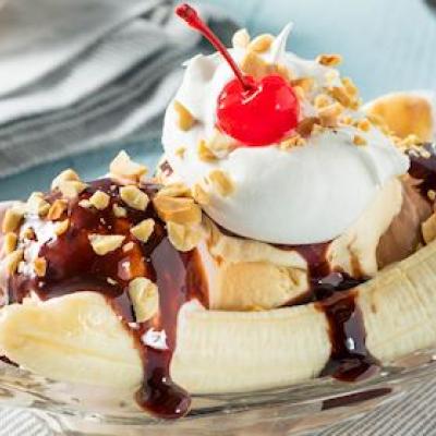 Banana split with cherry, whipped cream, and fudge