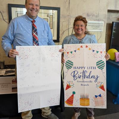 Two people holding a Happy Birthday Goodlettsville Branch card.