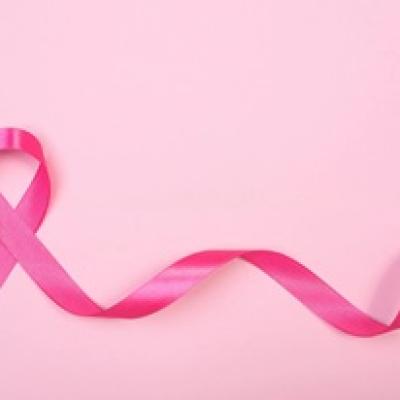 Pink ribbon on a light pink background.