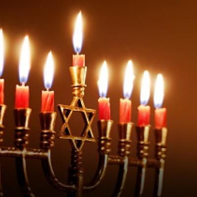 Hanukkah menorah with lit candles. 
