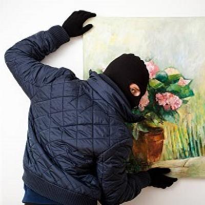 Burglar stealing a painting.