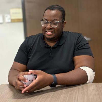 Staff person Lavelle holding cards.