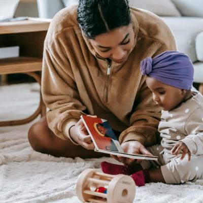 Family with baby enjoys a shared reading experience.