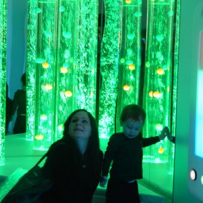 Two people in a room lit with green lights.
