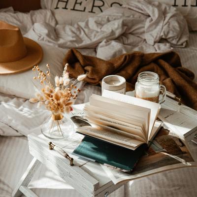 open book with pages showing, coffee and tea cups and flowers