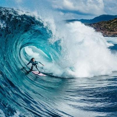 Big ocean wave crashing on a beach.
