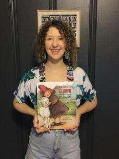 Corrie Jones holding the book Maria Had a Little Llama