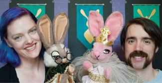 Smiling man and woman each holding a rabbit puppet. 