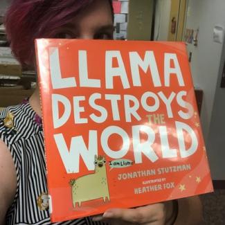 Photograph. Sign reads "LLAMA DESTROYS WORLD."
