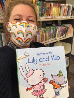 Woman holding book called Lily and Mio.