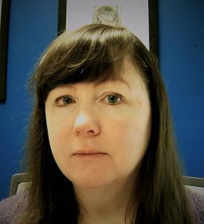 Headshot of woman with dark brown hair.