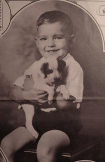 A young boy holds a dog
